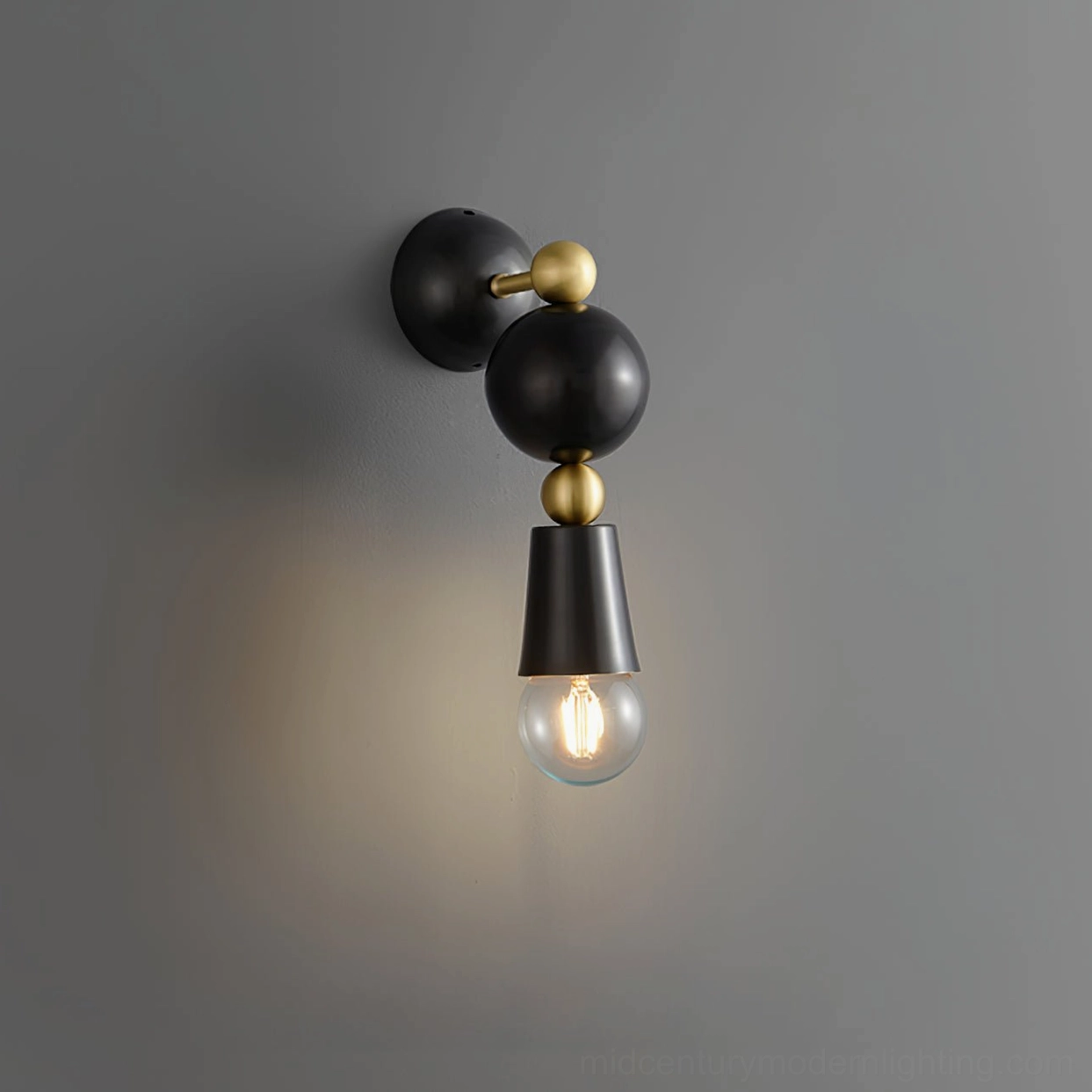 Spindle mid-century modern wall sconce in brass and black two-tone finish