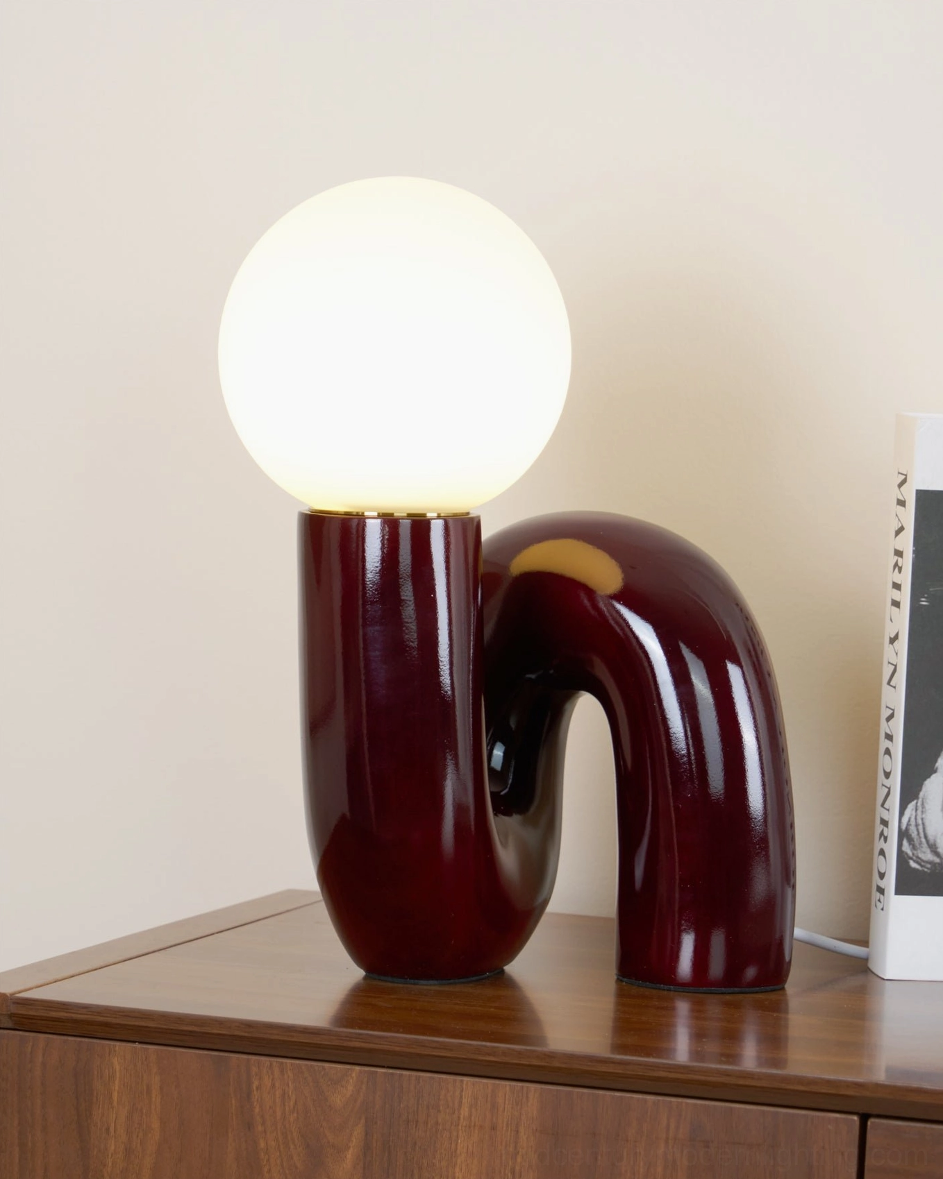 Spiral Glass Table Lamp illuminated front view on light background showing luminous glass and resin construction