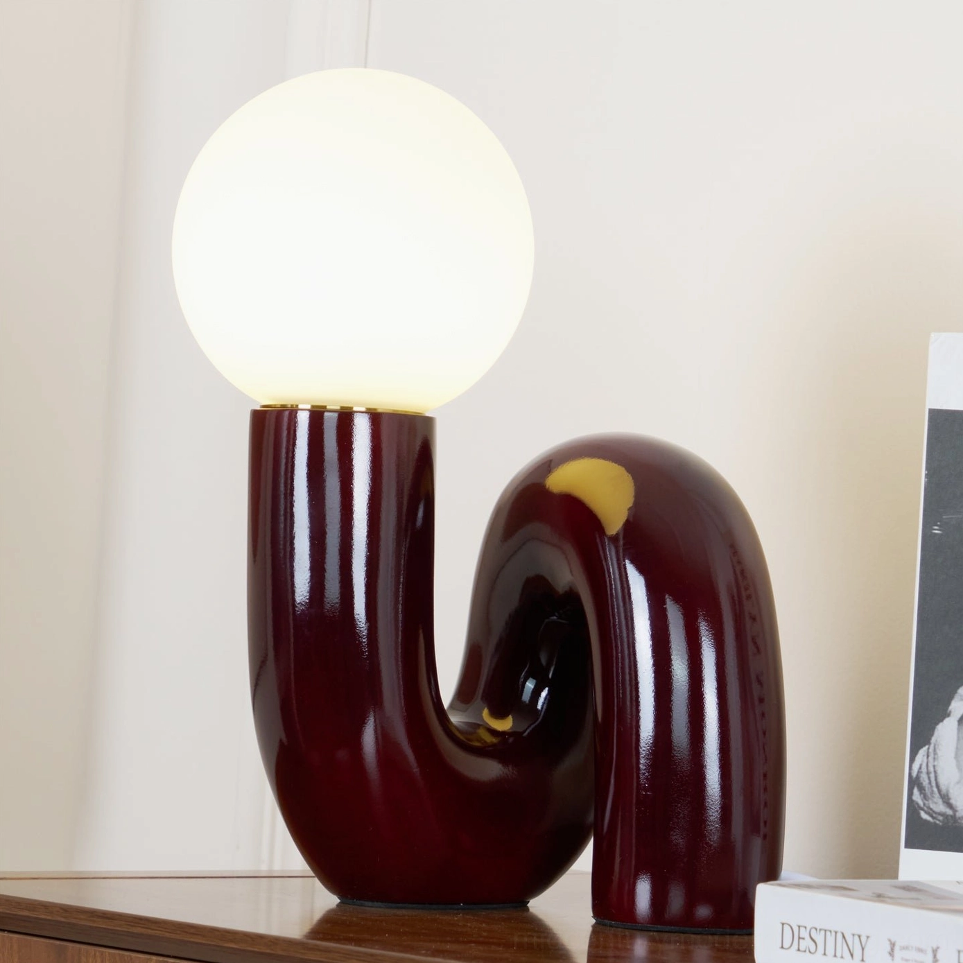 Close-up detail of Spiral Table Lamp glossy maroon ceramic base showing smooth curved sculptural form