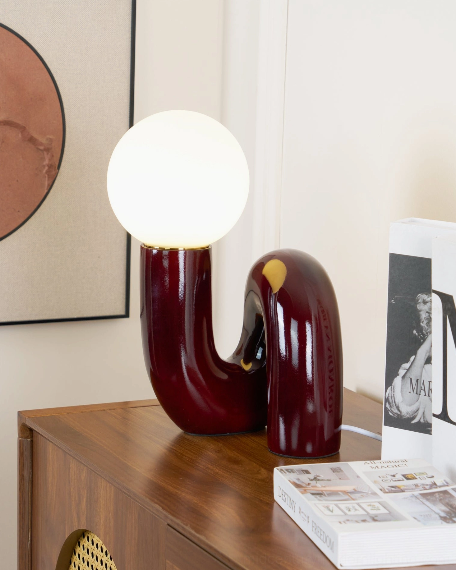 Spiral Table Lamp in warm home setting on wooden side table with books and wall art, demonstrating interior design application