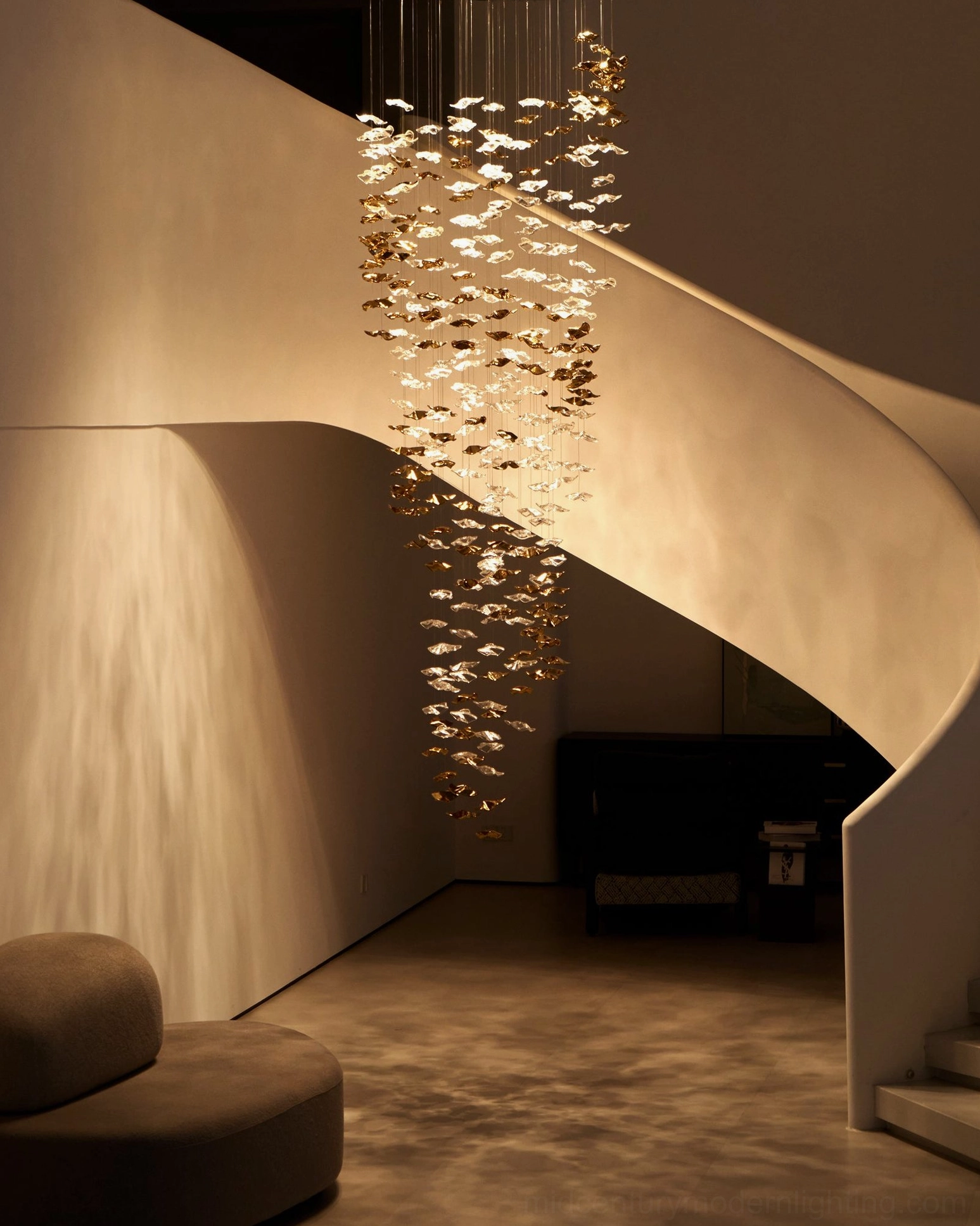 Modern cascading chandelier in contemporary villa spiral stairs with mixed clear and golden glass elements