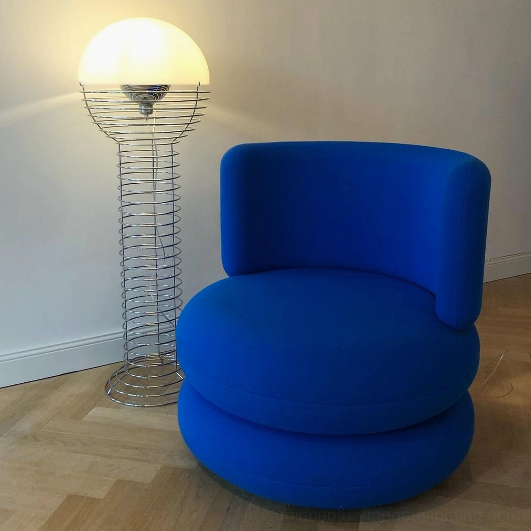 Spiral wire floor lamp in modern living room with blue accent chair, chrome wire frame with warm glowing hemispherical shade