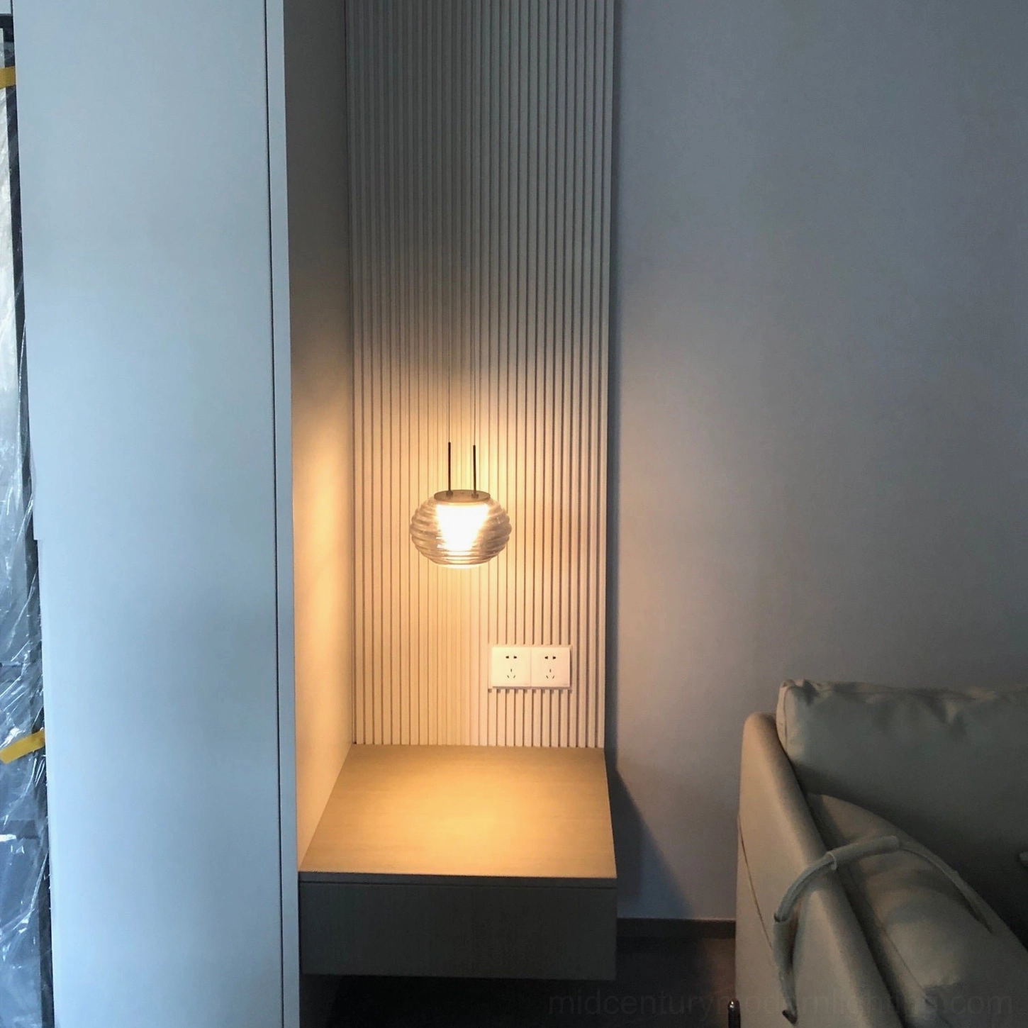 Splugen pendant lamp demonstrating luminous performance with ribbed glass light diffusion in interior setting