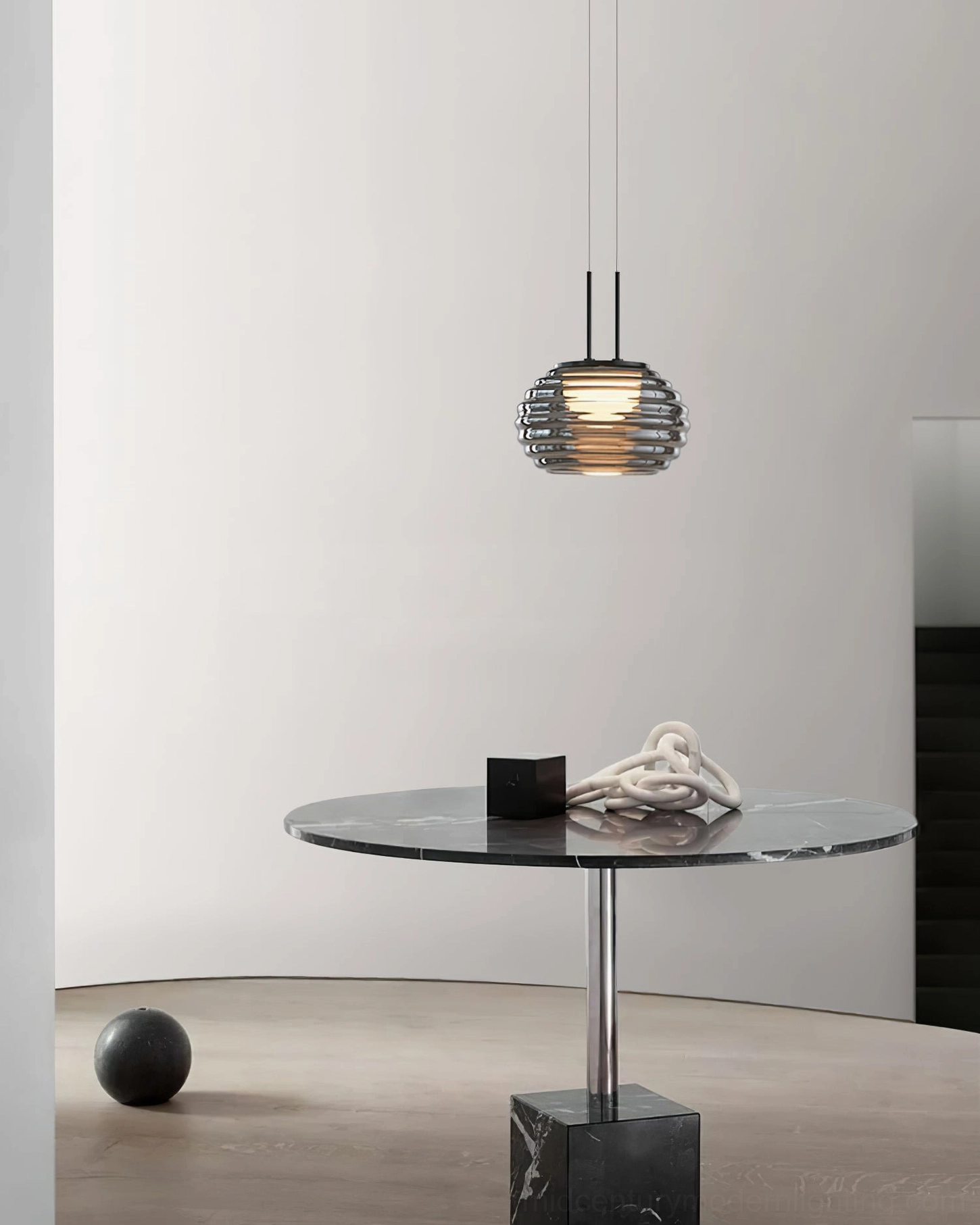 Splugen pendant suspended above modern minimalist seating area with side table and sleek contemporary décor