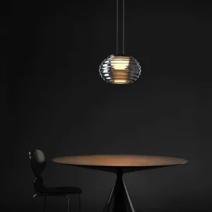 Splugen pendant lamp suspended in modern minimalist dining corner with warm ambient lighting and luxury contemporary style