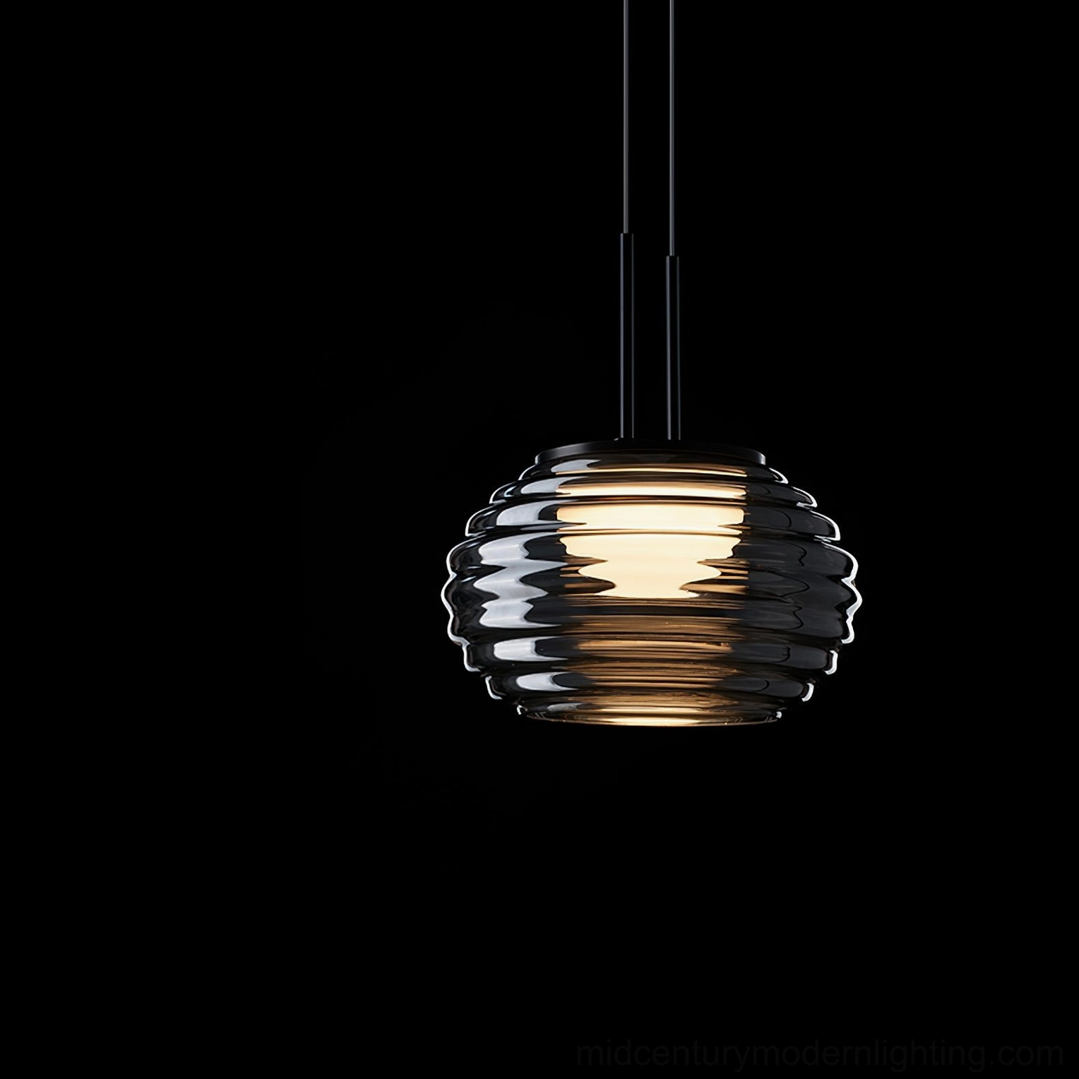 Splugen smoke grey pendant showing ribbed texture detail and warm light glow through glass