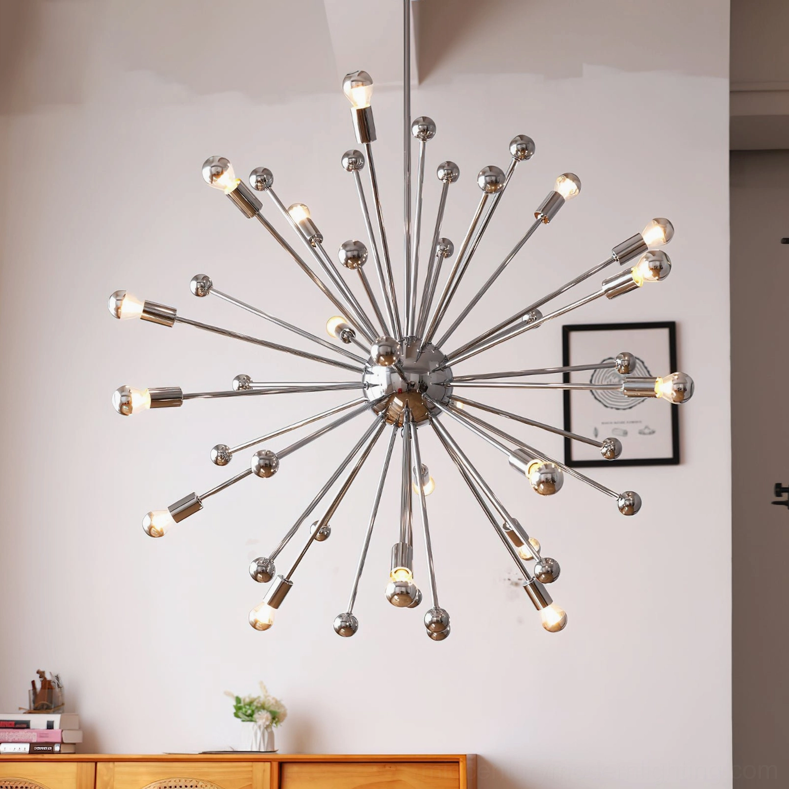 Mid-century modern sputnik chandelier with warm Edison bulbs illuminated in contemporary home entryway