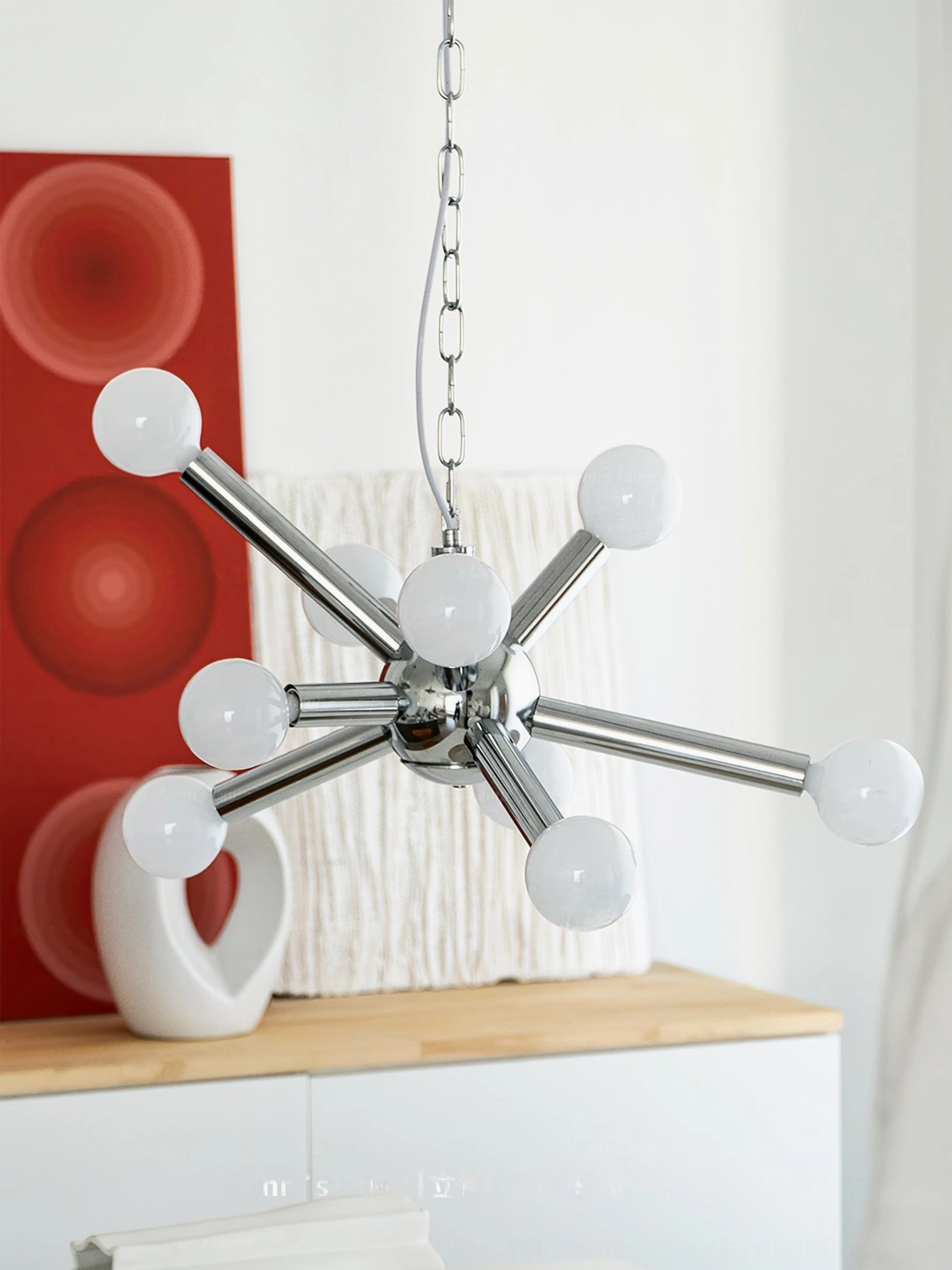 Modern home with Sputnik atomic age chandelier, red wall art decor, white ceramic accents, contemporary styling