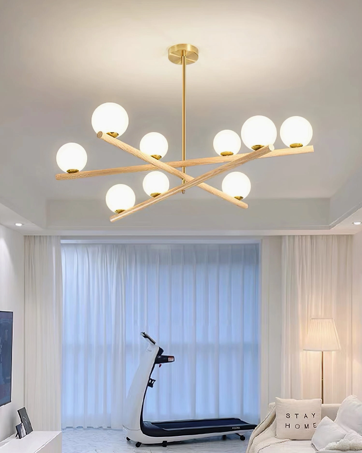 Nordic minimalist interior with sputnik wood chandelier above seating area, full room perspective with natural light and modern furniture