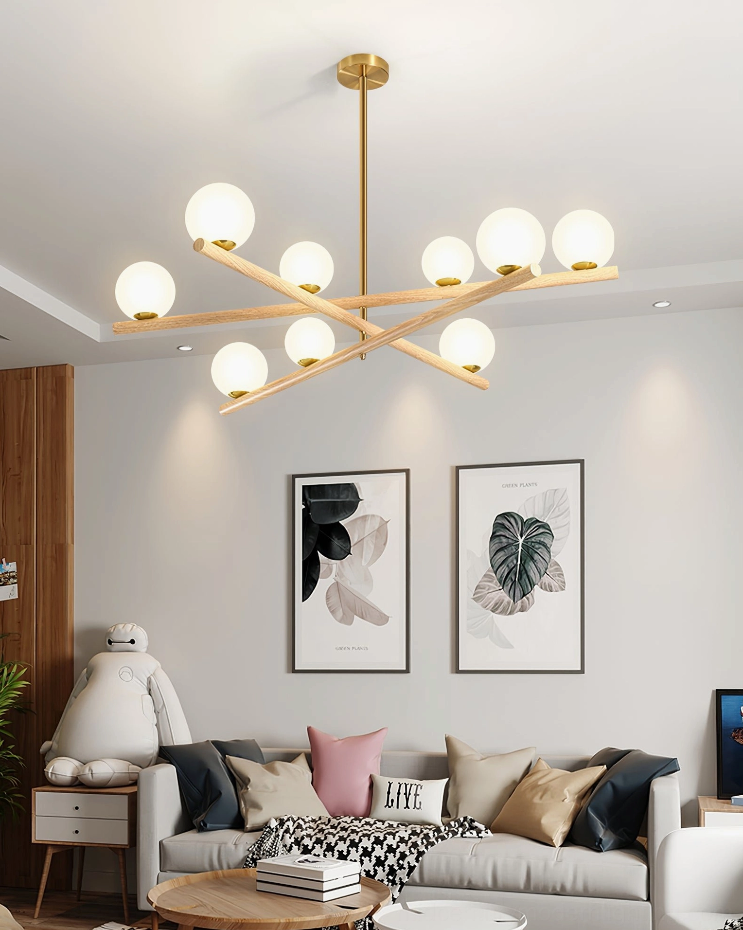 Warm Nordic interior with wood and gold sputnik chandelier above upholstered furniture and wall artwork
