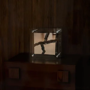 Contemporary square glass table lamp with cracked mirror design mounted on dark wood bedside table - bedroom setting