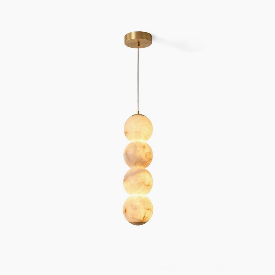 Stacked alabaster globe pendant light with brass hardware on white background, front view