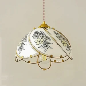 Close-up detail of stained glass lily pendant showing exposed E26 socket, twisted brass wire suspension, and decorative metal bottom trim