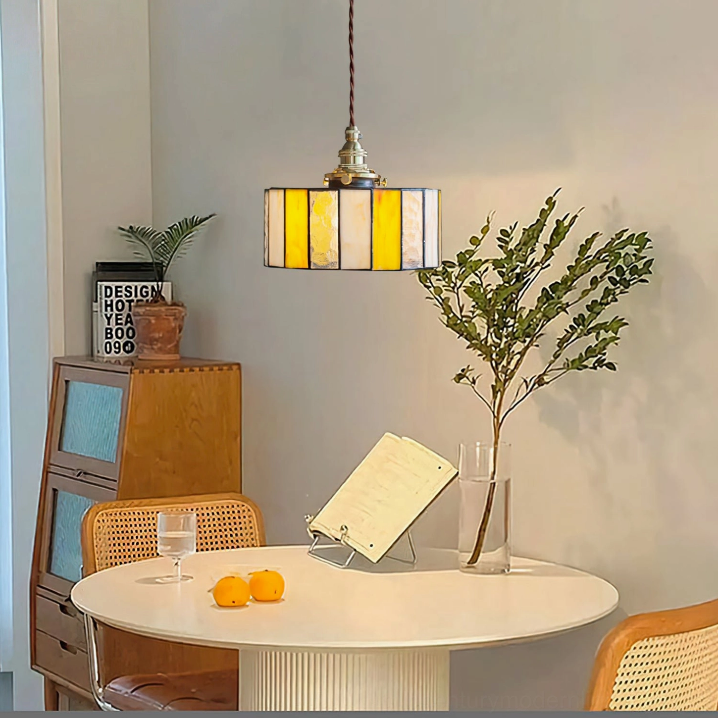 Complete stained glass drum pendant lamp featuring warm amber panels and bronze brass fixture in ceiling mount configuration