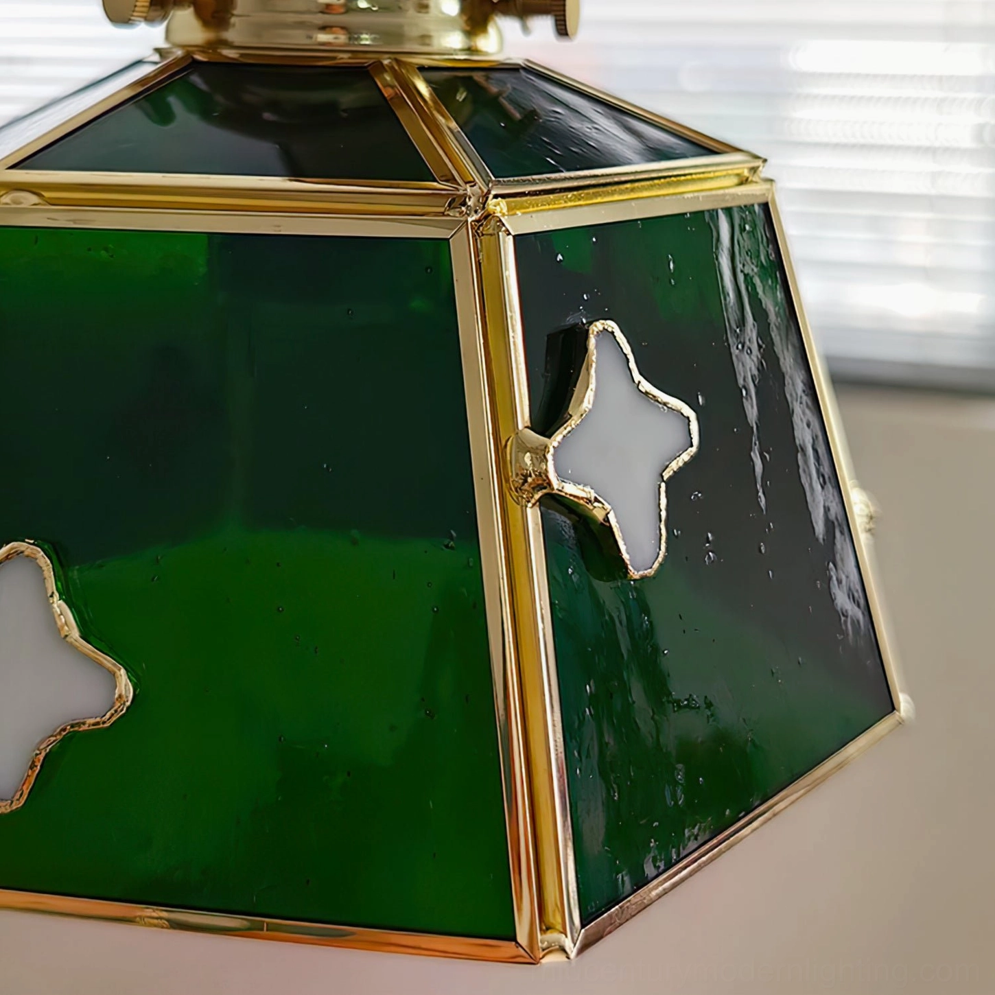 Stained glass pendant lamp creating jewel-tone light effect in eclectic bohemian interior space