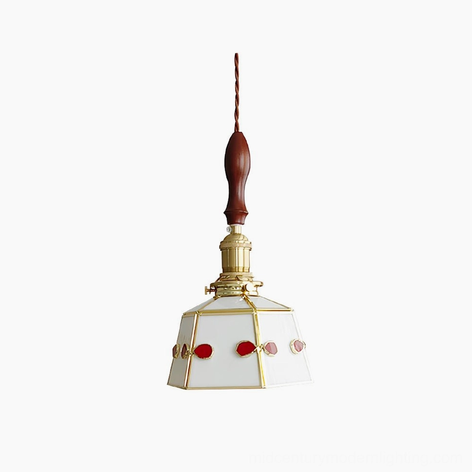 Handcrafted stained glass pendant lamp with polished brass frame and walnut handle—front studio view