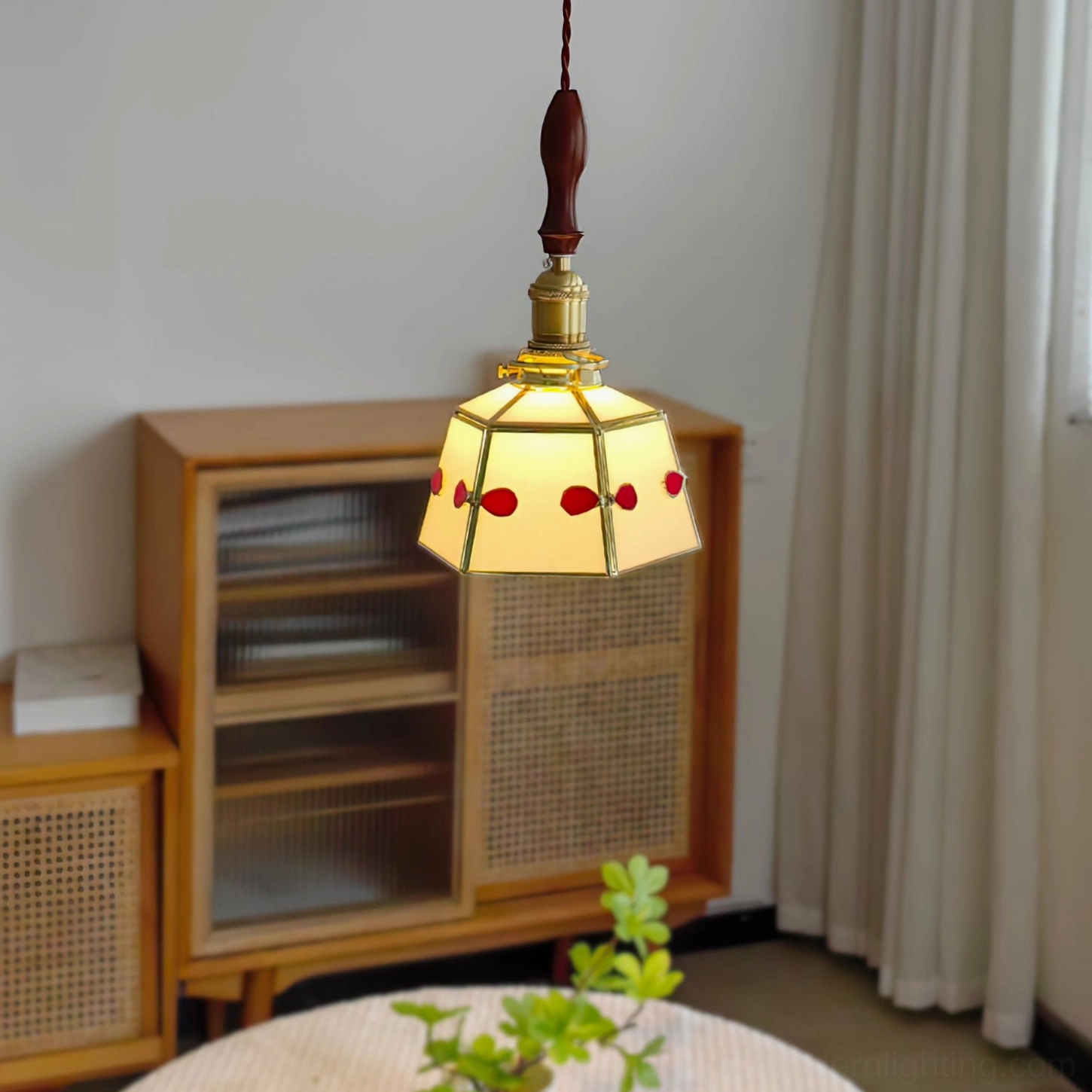 Lit stained glass pendant lamp casting warm red-toned light in Japanese-style living room—low angle view