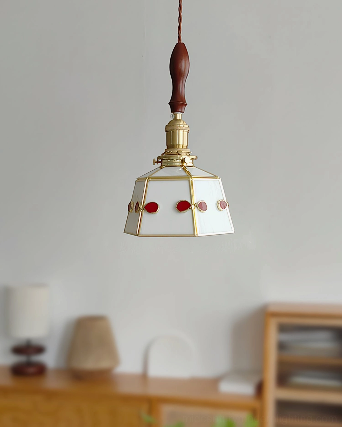 Artisan stained glass pendant lamp displayed on table with vintage furniture and traditional home decor