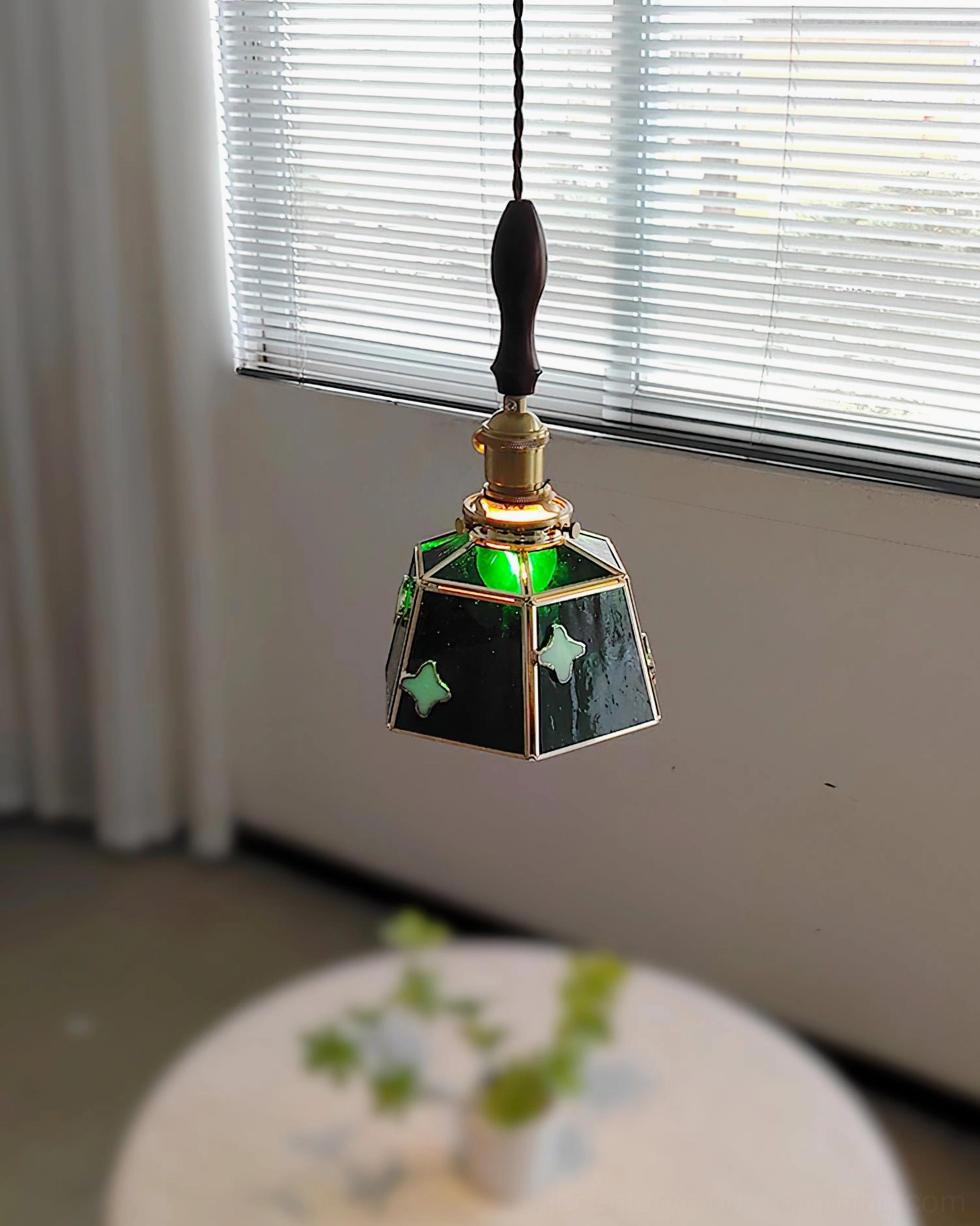 Walnut wood handle detail of stained glass pendant lamp showing turned craftsmanship and natural finish
