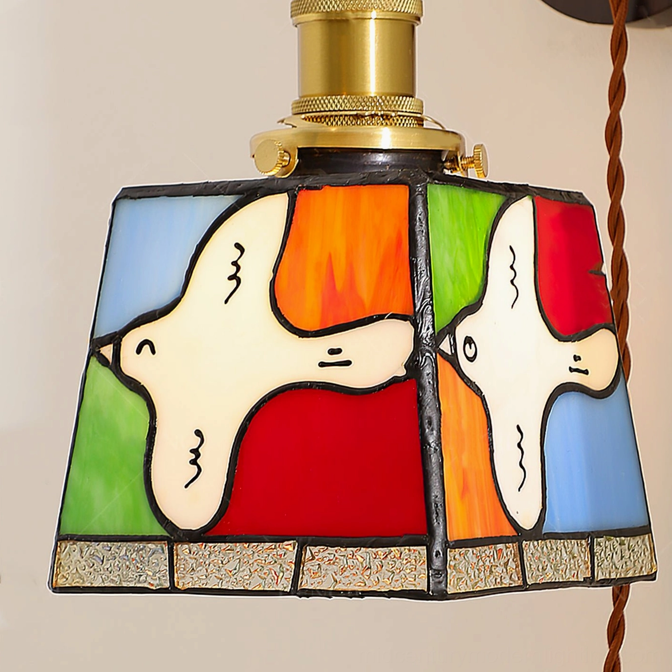 Close-up detail of handcrafted stained glass shade featuring white peace dove motifs on multi-color glass panels