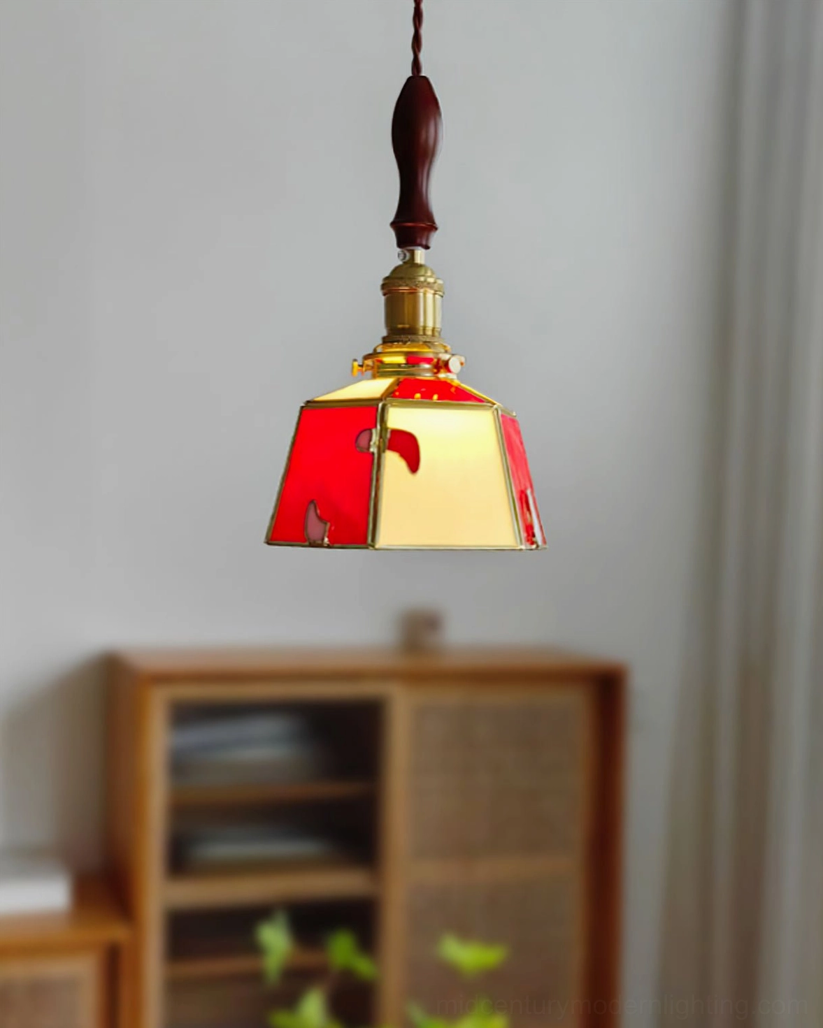 Handcrafted stained glass shade close-up showing polished brass structural frame and artisan glass work
