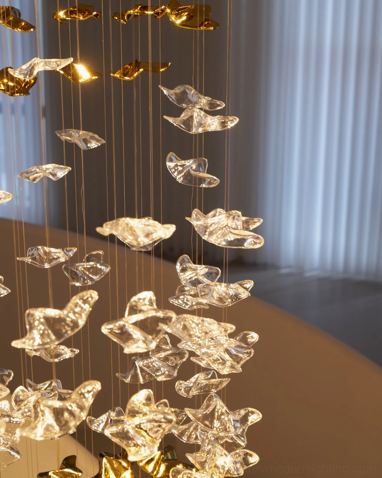 Staircase chandelier side view mixed clear amber glass pendants warm lighting with curtain window