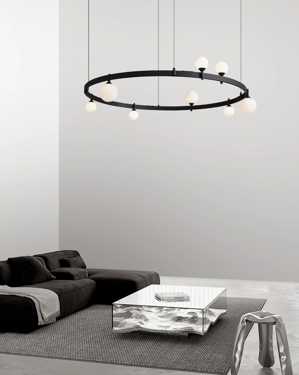 Black ring globe chandelier low side angle view in dark-toned modern living room with cozy minimalist decor