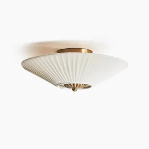 Stefanie pleated semi-flush ceiling lamp with off-white fabric shade and brass gold hardware, overhead view against minimalist white wall