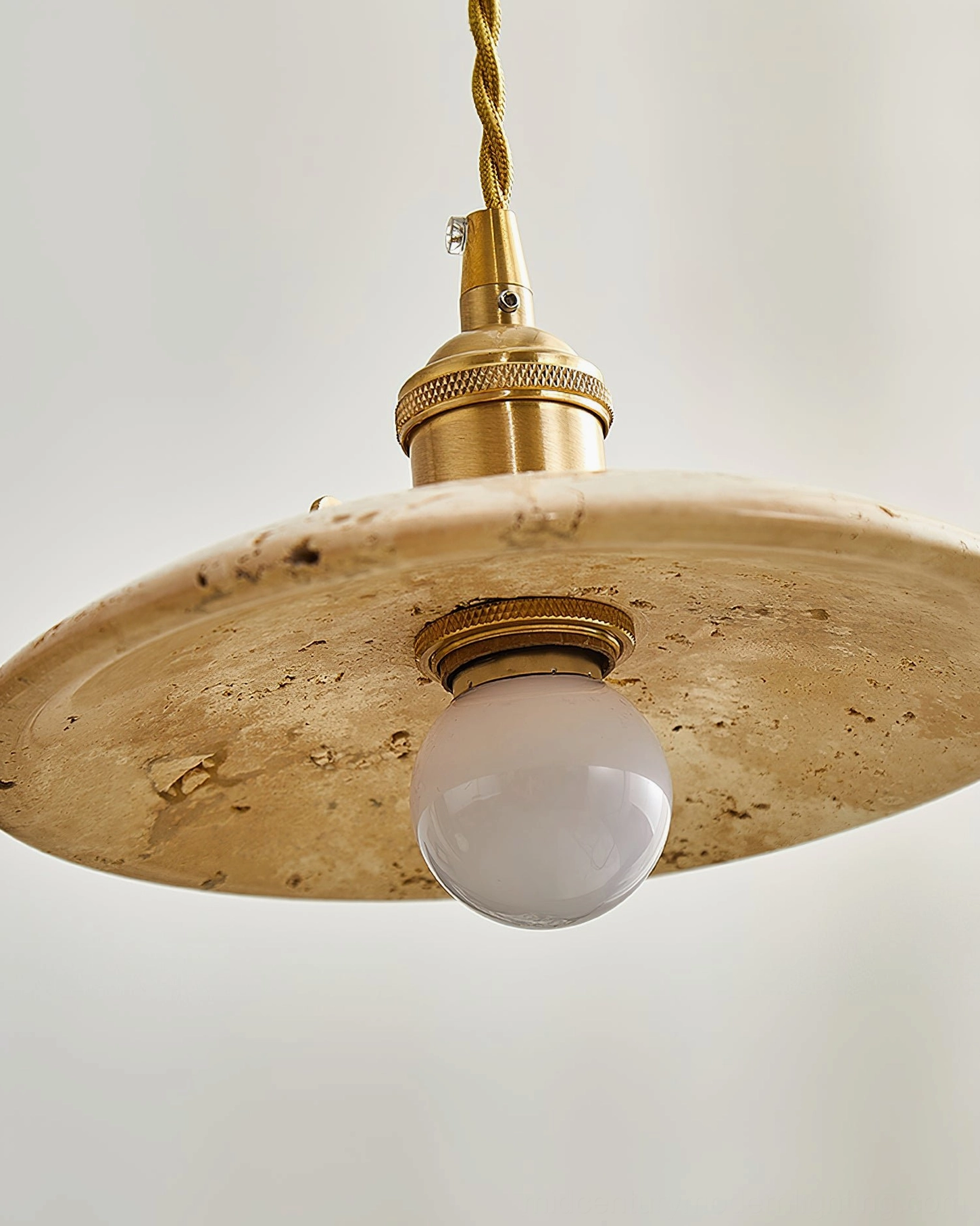 Stella pendant light installation view showing ceiling-mounted fixture with travertine shade and fabric cord in modern home environment