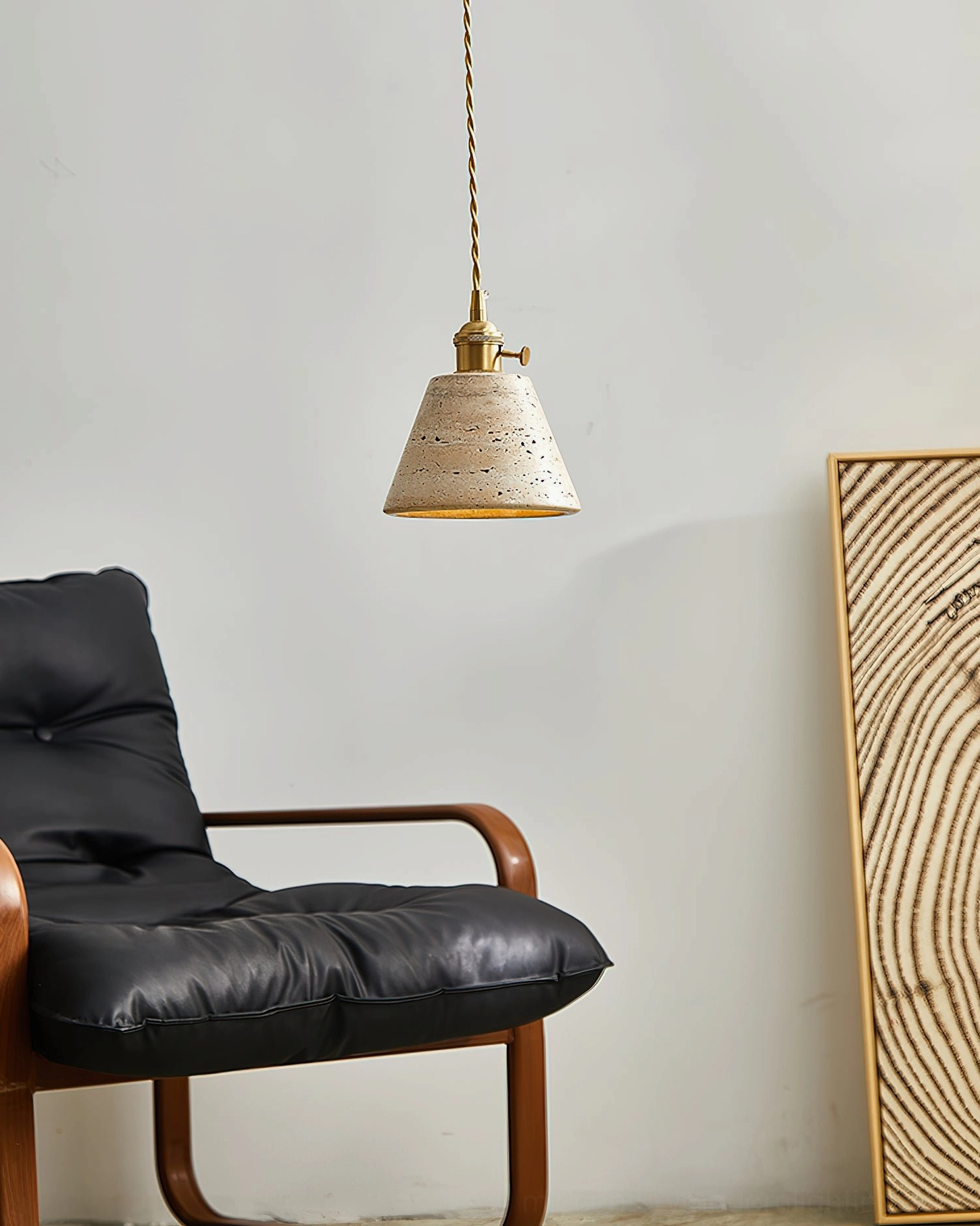 Stella pendant light with twisted brass cord in contemporary minimalist living room with wall art, understated vintage mid-century style