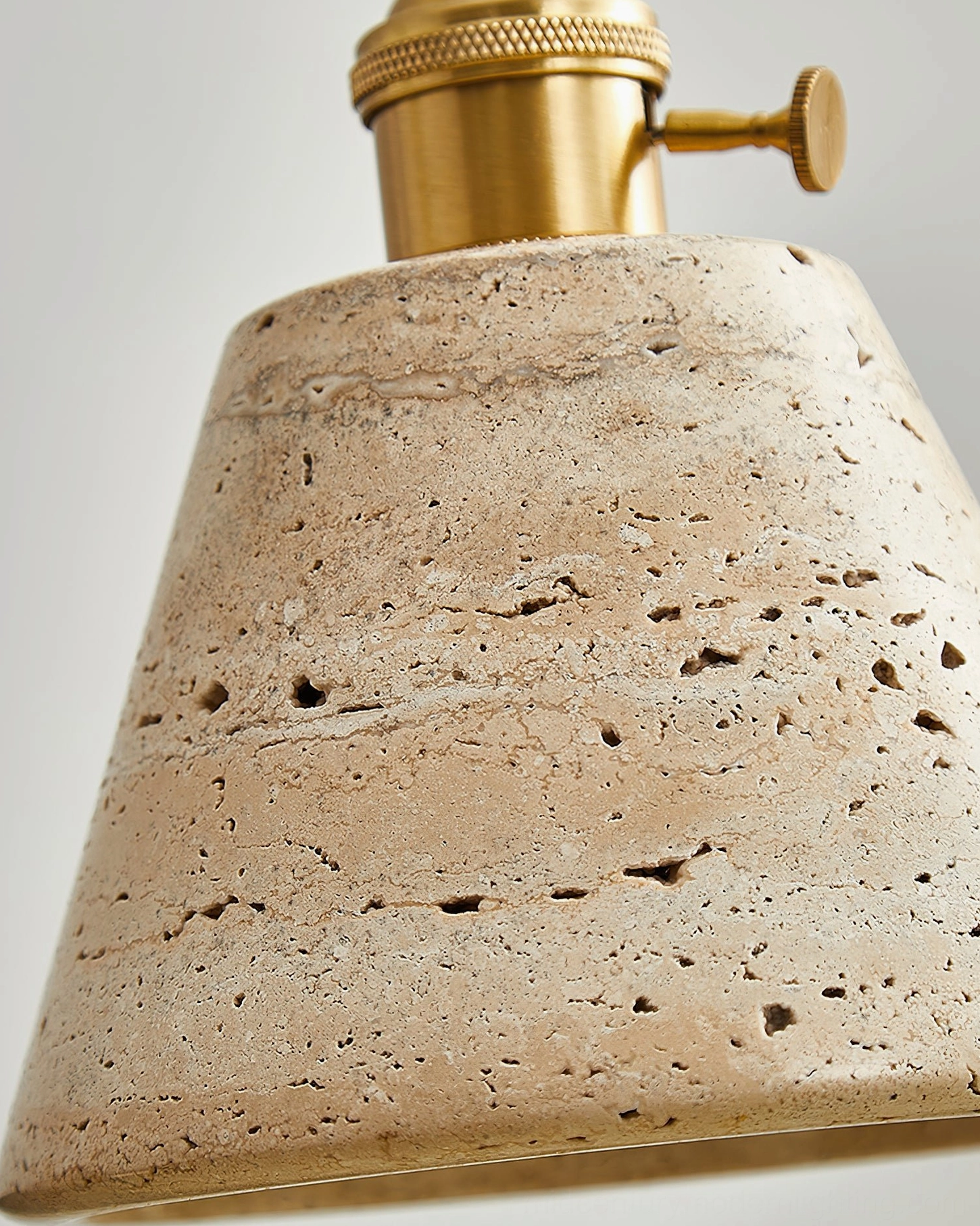 Stella travertine pendant light artistic view showcasing the natural stone craftsmanship and warm brass accents in home lighting design