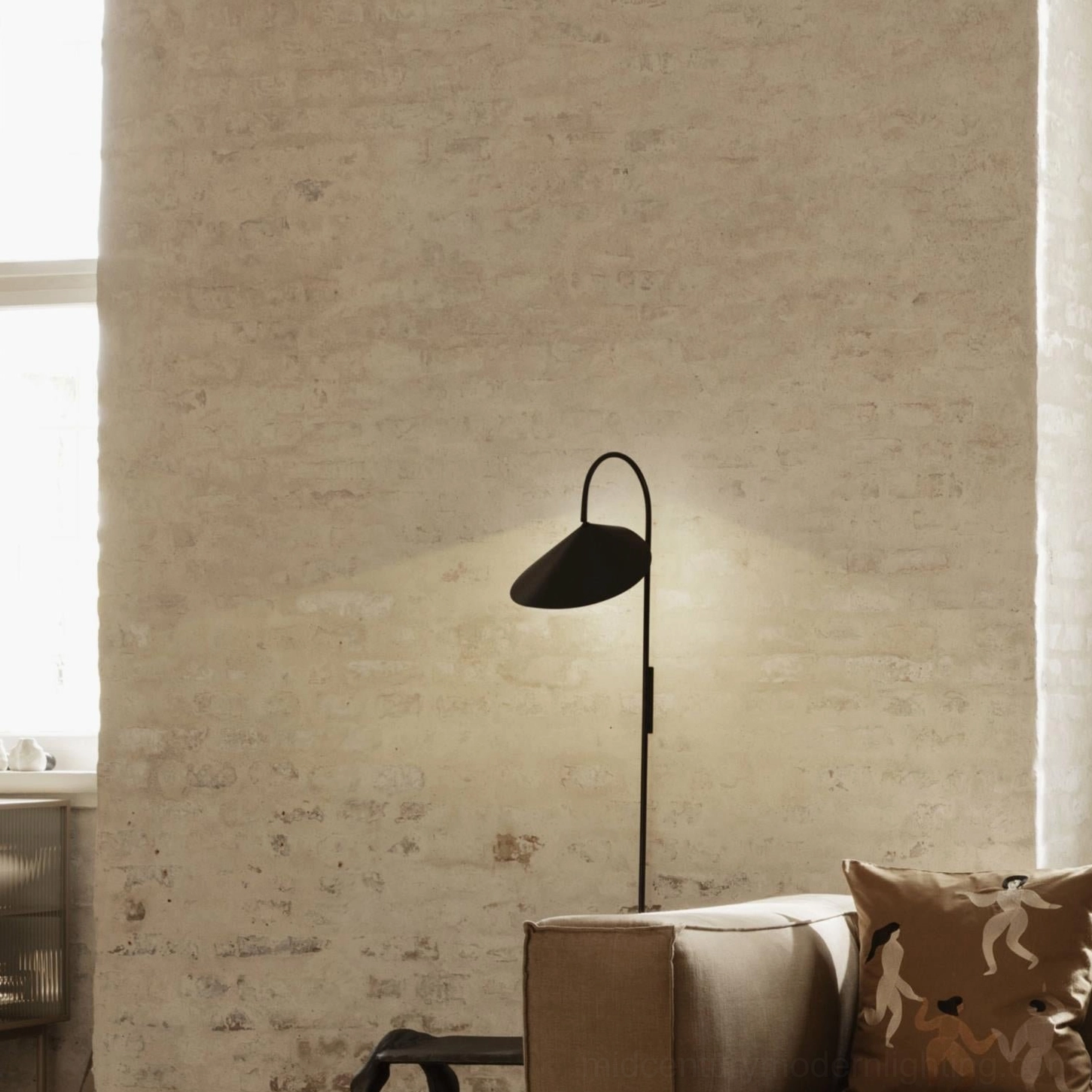 Black Stella wall lamp installation in contemporary minimalist living space with neutral palette