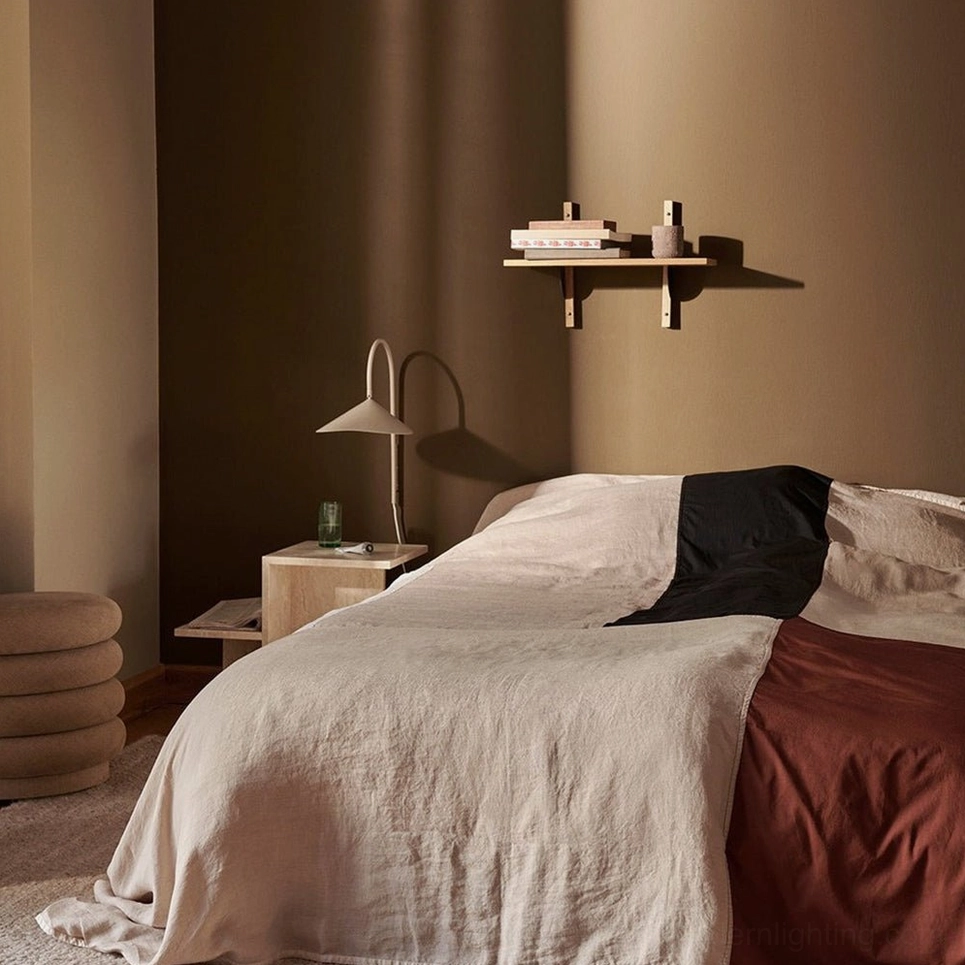 Stella wall lamp mounted on feature wall in double-height architectural interior space