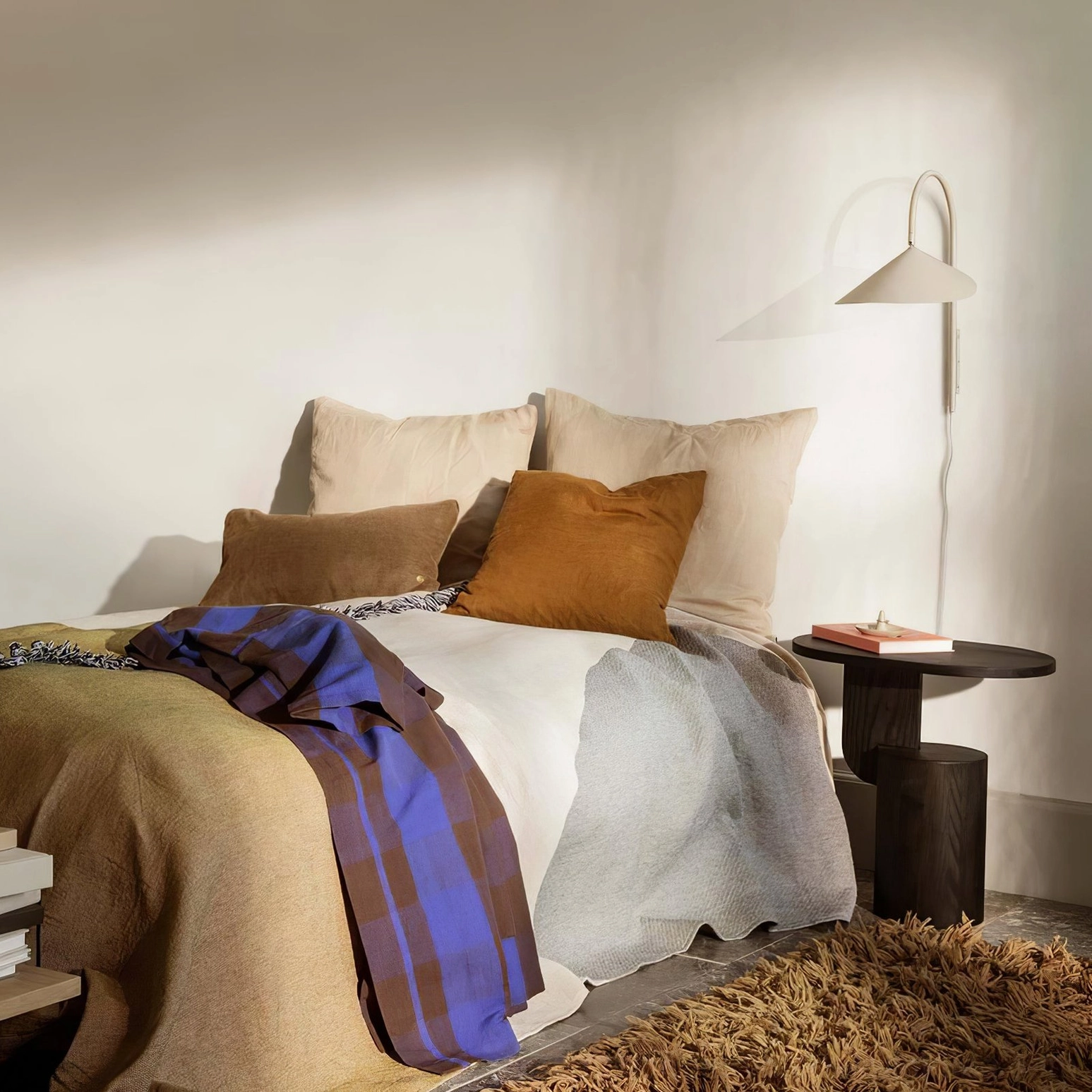 Tall 127cm Stella wall lamp creating ambient vertical light wash in stairwell installation