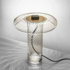 Close-up detail of Stellar table lamp brass top hardware and smoked clear glass finish with black power cord