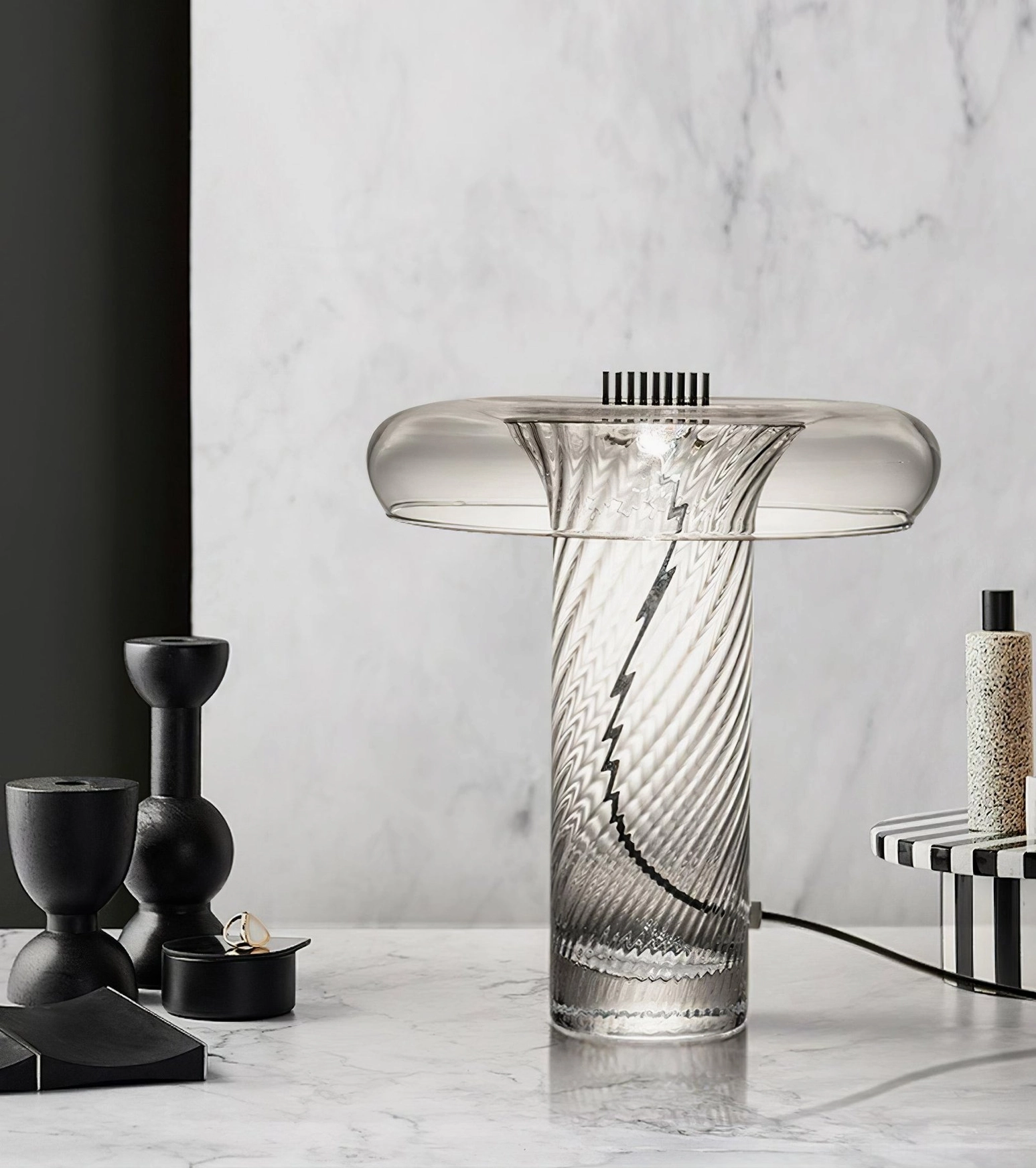 Stellar vintage glass LED lamp with brass hardware on luxury marble side table, paired with black candle holders