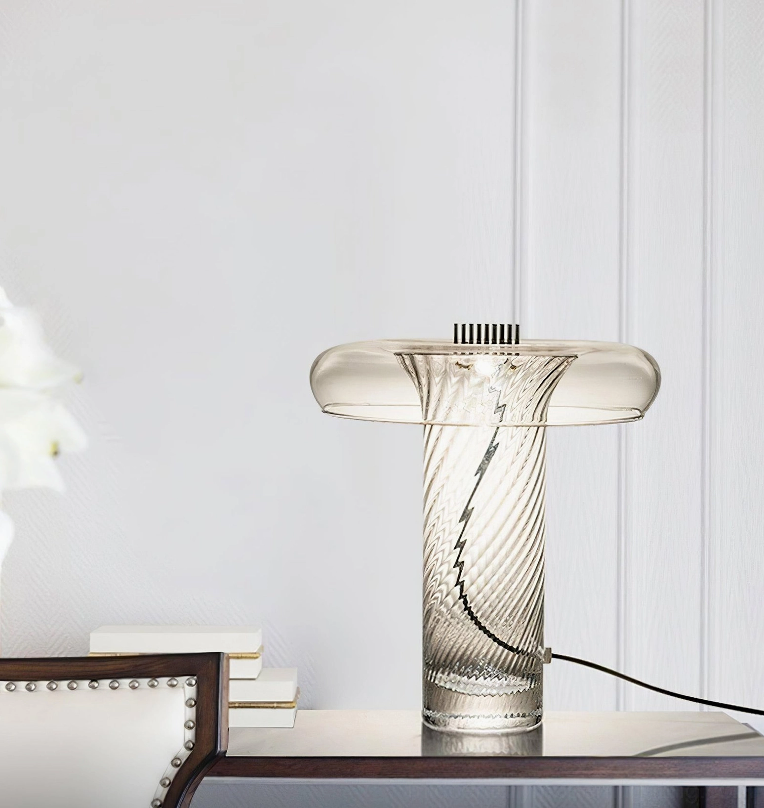 Stellar LED table lamp on home office desk with stacked books and modern workspace, three-quarter view