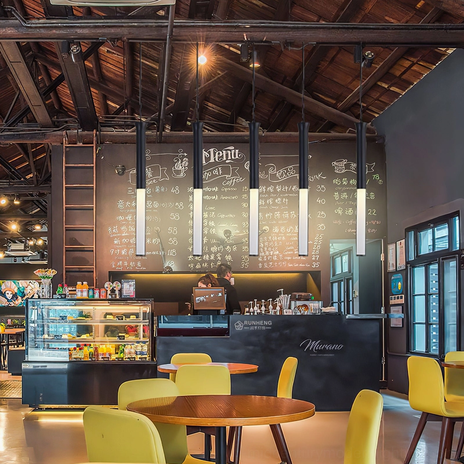 Row of Stick LED pendant lights in rustic industrial coffee shop with warm lighting and wooden truss ceiling