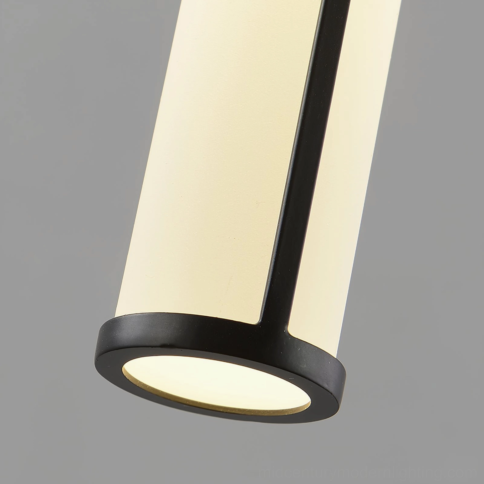 Close-up detail of Stick LED pendant showing black metal frame, frosted acrylic shade, and bottom light port