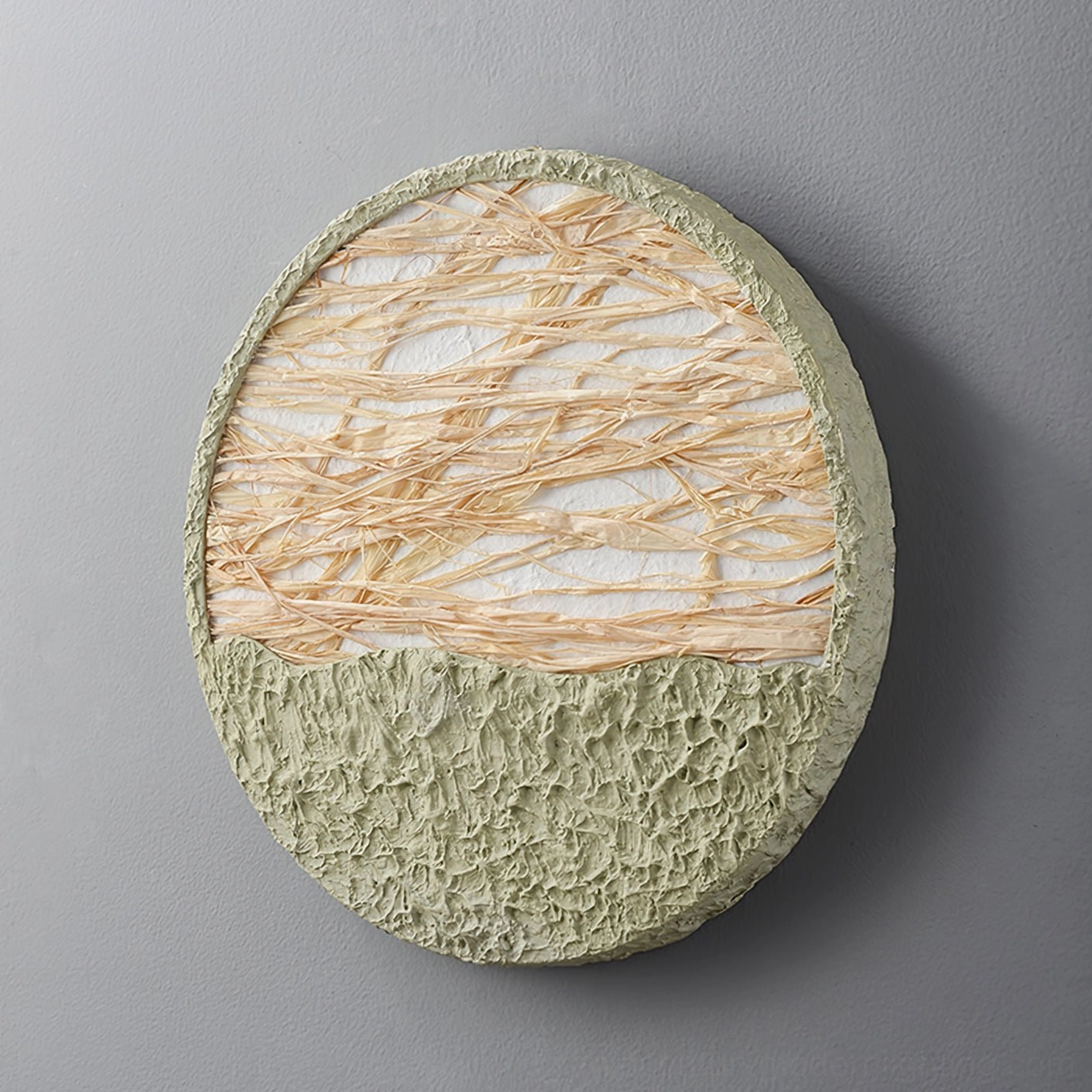 Straw wall lamp artistic detail shot - natural fiber construction with light green base accent biophilic design