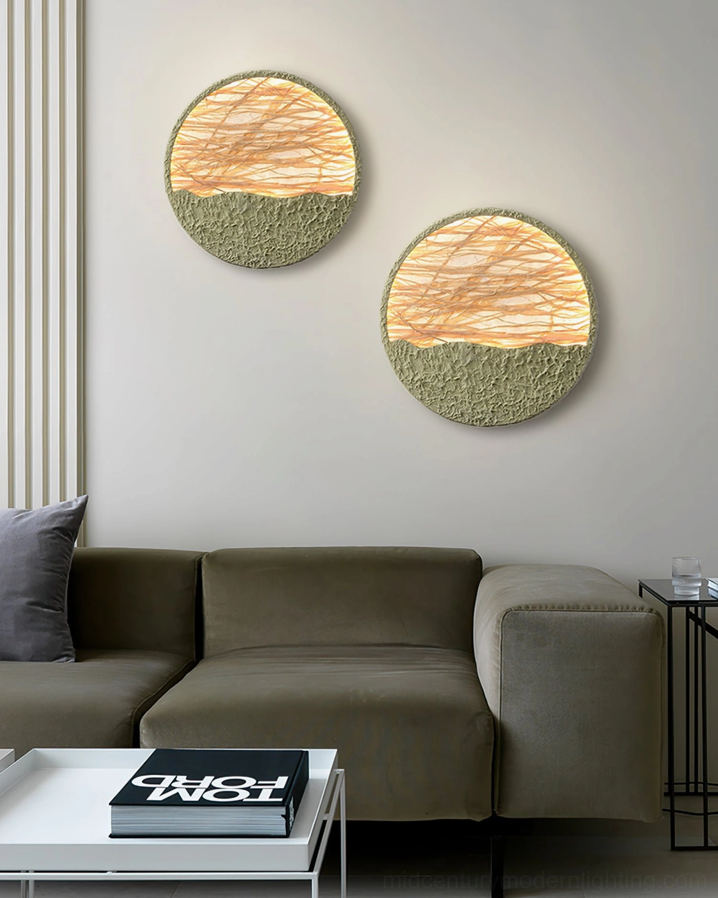 Two illuminated straw wall lamps in modern minimalist living room with taupe sofa and decorative coffee table books