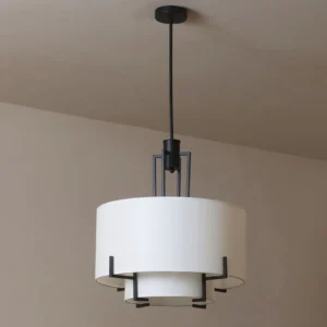 Strum modern pendant lamp suspended from black rod, showing layered fabric shade structure and metal frame details