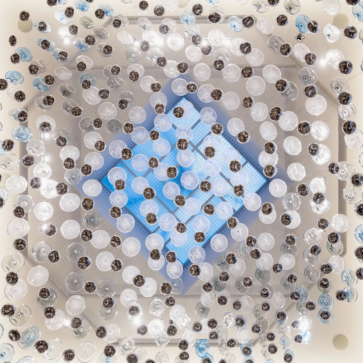 Surge Glass Cloud Chandelier dense cluster overhead view - grid-pattern arrangement of suspended glass elements with blue accent