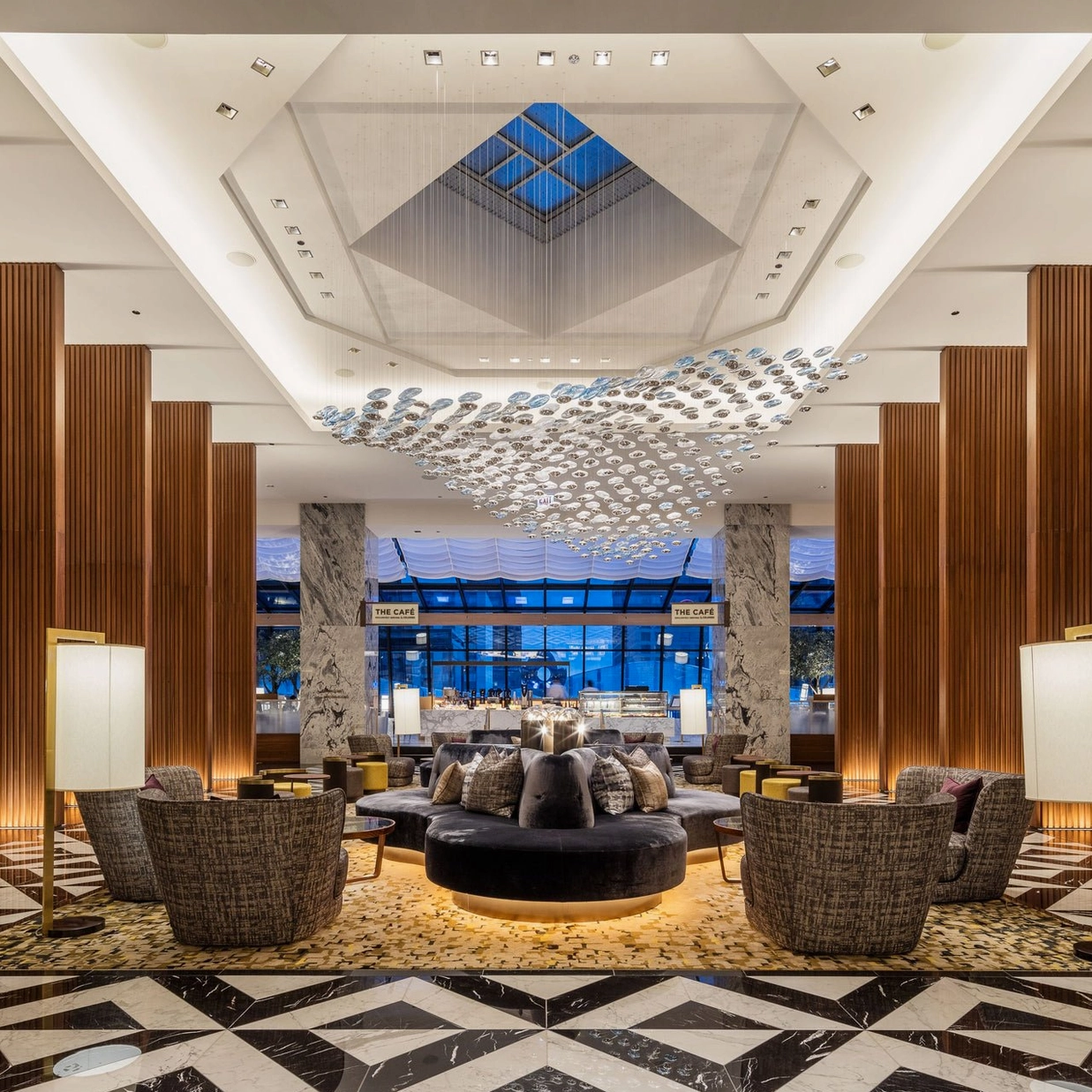 Surge Glass Cloud Chandelier overhead view in contemporary hotel lobby - architectural ceiling statement with wave-form glass arrangement