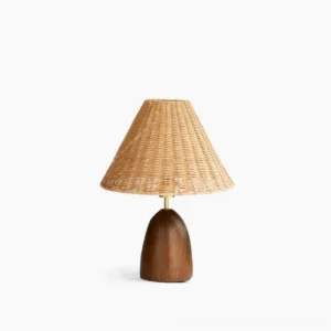 Suri rattan table lamp with woven natural rattan shade and walnut wood pedestal base on white background, front view