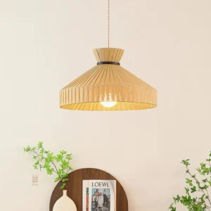 Surora pendant light illuminated with warm glow, overhead view showing black hanging cord and pleated fabric diffusion