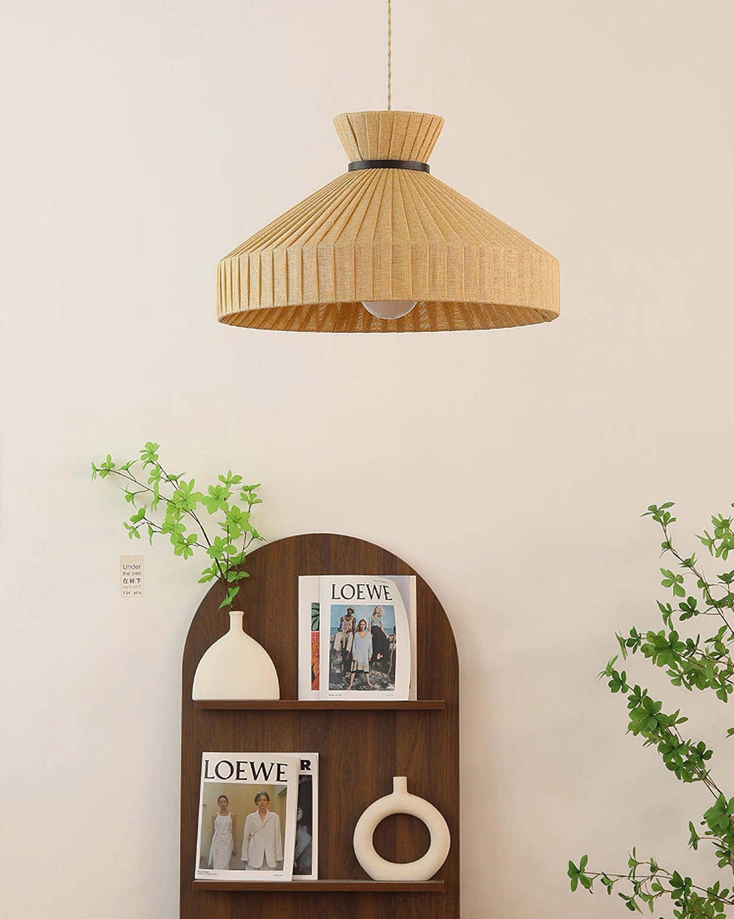 Surora pleated shade pendant light bottom angle with shelf and green plants backdrop, solid woven aesthetic
