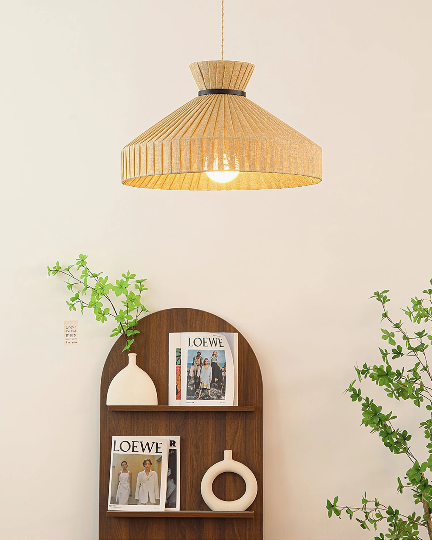 Small Surora pleated pendant light displayed on shelf with minimalist decor background, side overhead angle