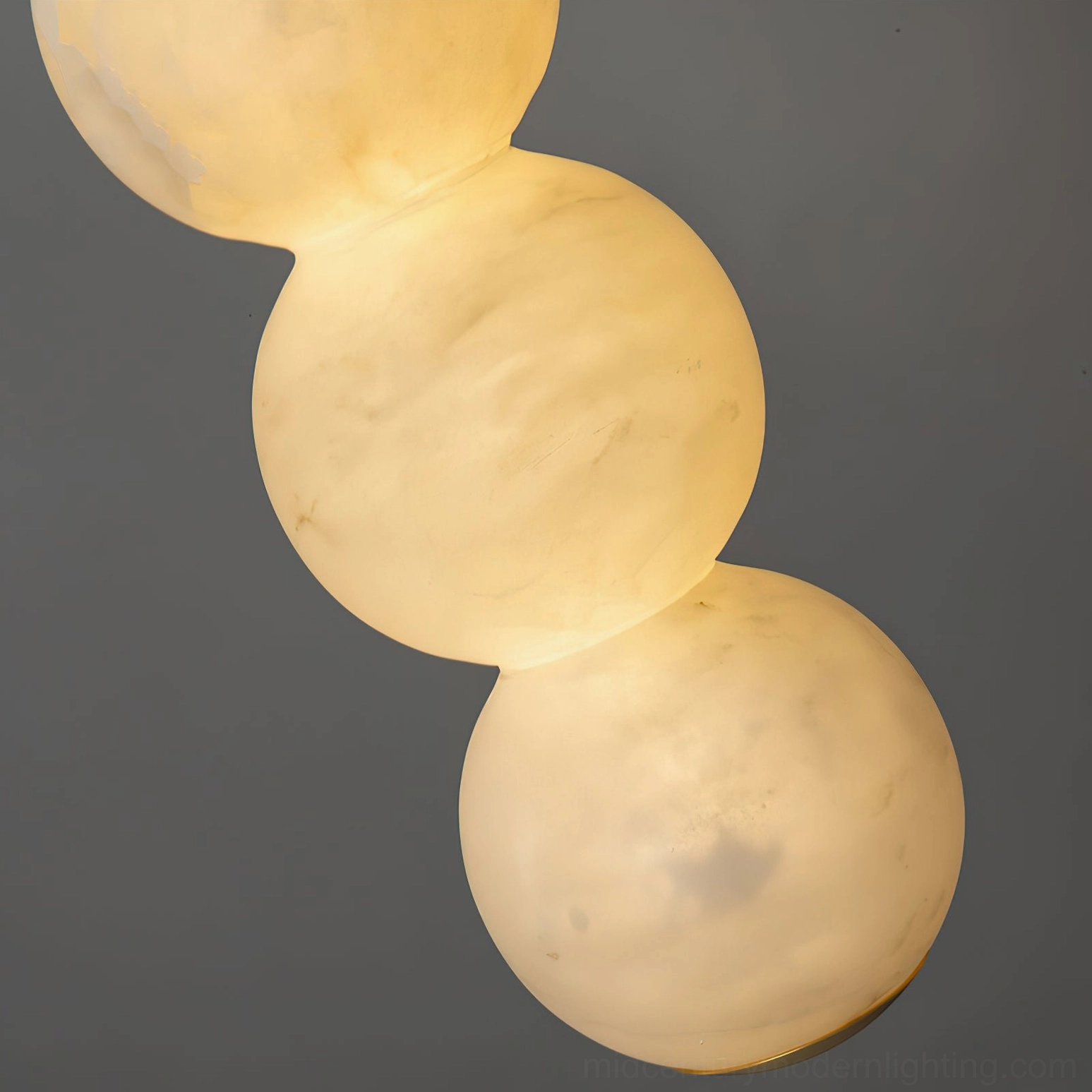 Suspended stacked alabaster pendant creating sculptural focal point contemporary interior