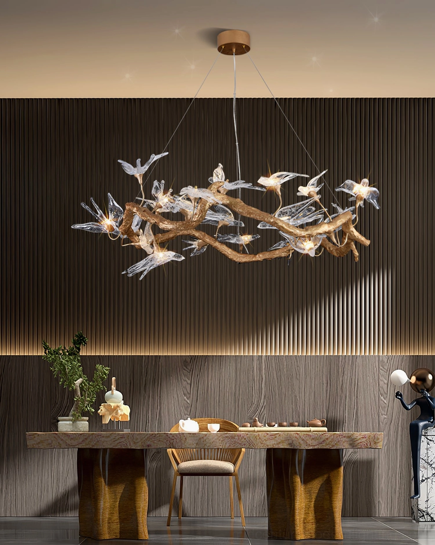 Brass swallow chandelier close-up showing crystal bird ornaments and branch structure detail